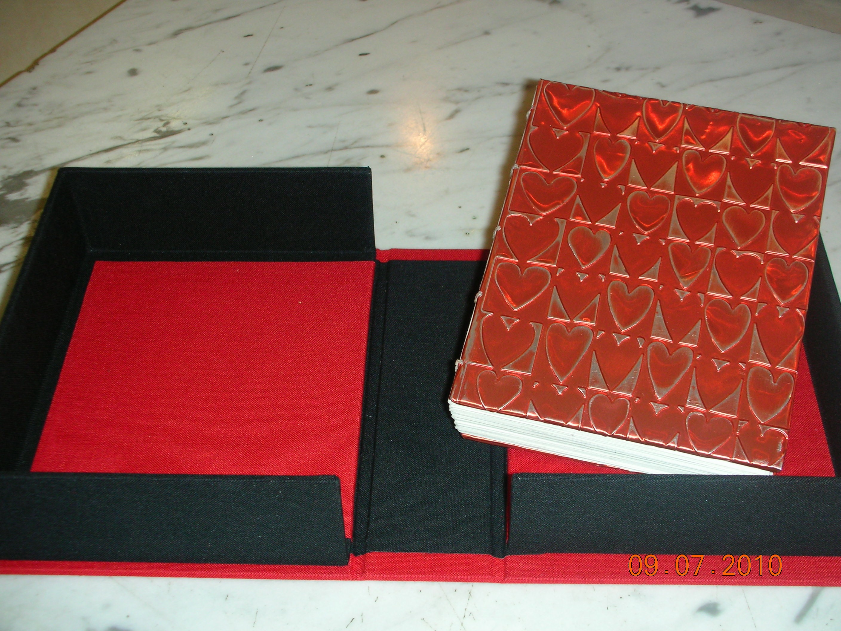 Book with aluminum embossing in clamshell