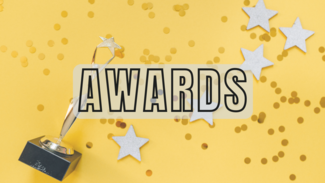 trophy on yellow background with paper stars and Awards written on top